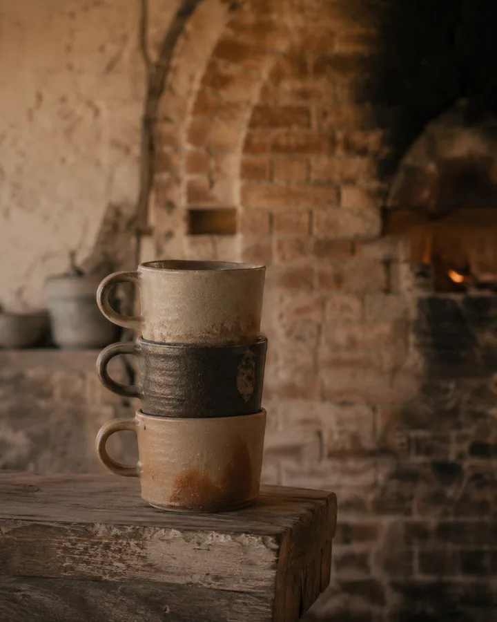 Glowing coals inside the wood-fired kiln's firebox at João's studio.