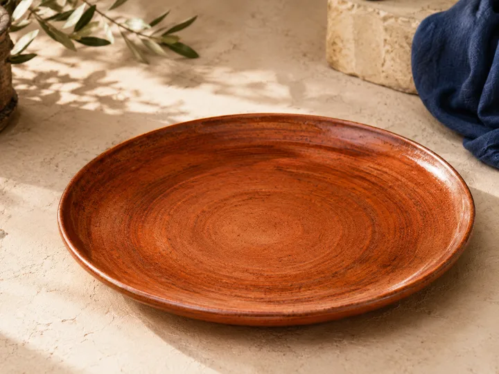 Rustic Charger Plate in Burnt Sienna — wheel-thrown with warm pooled glaze.