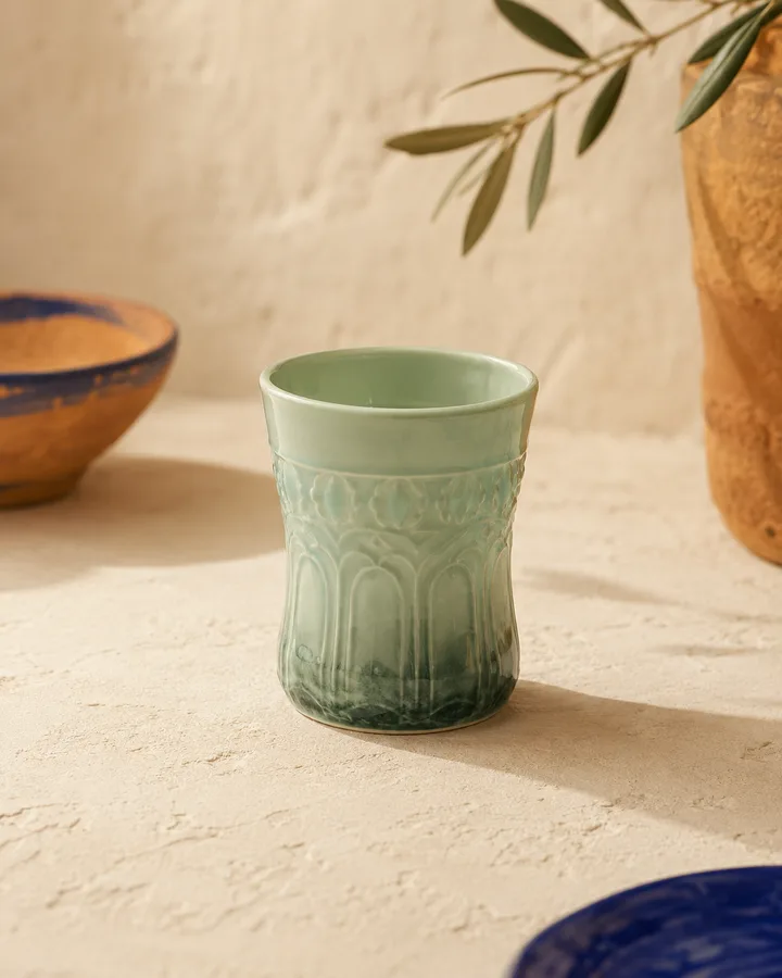 Tea Tumbler in Mint Glass — translucent mint-green porcelain tumbler.